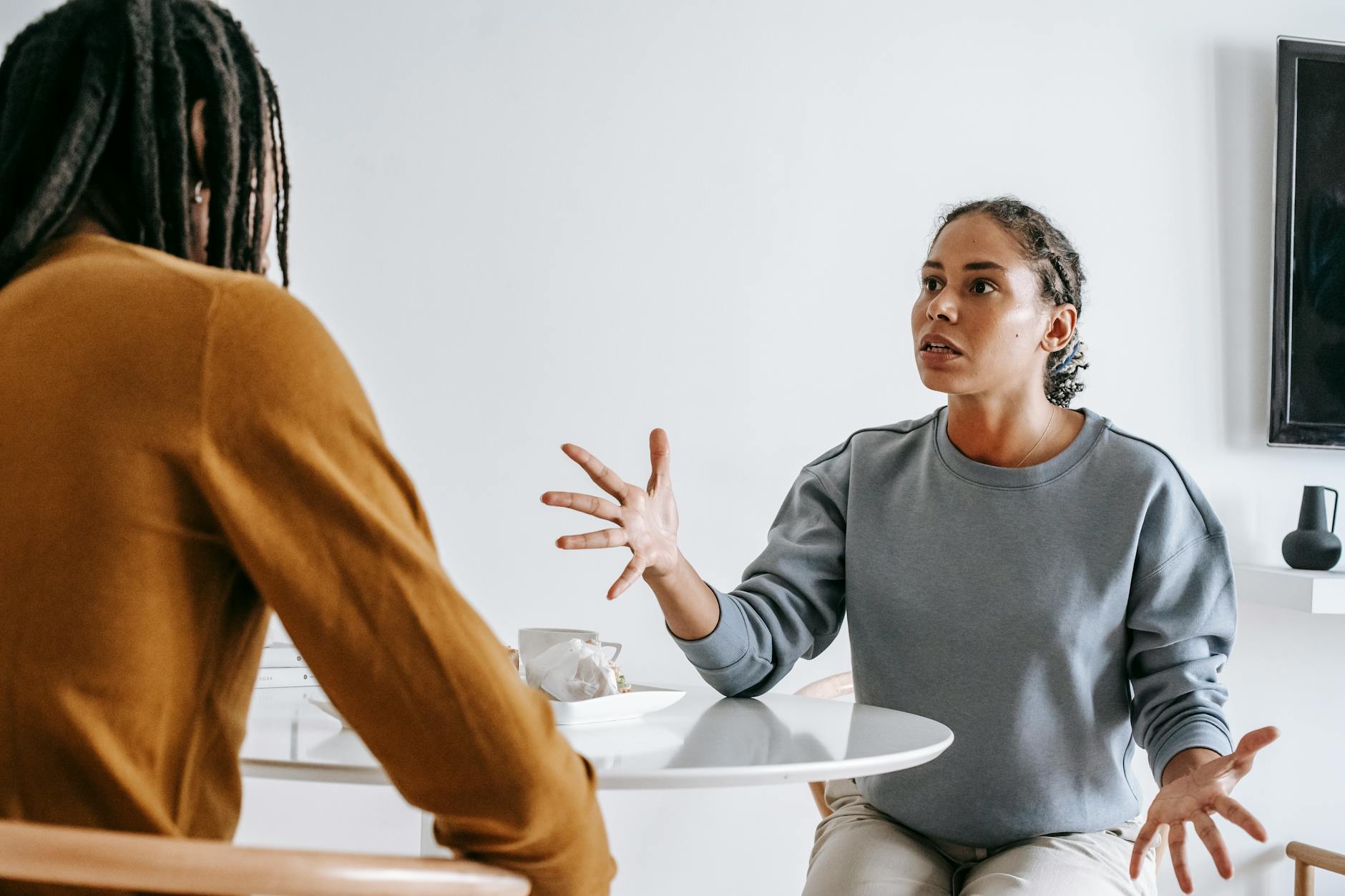 african american couple arguing at table