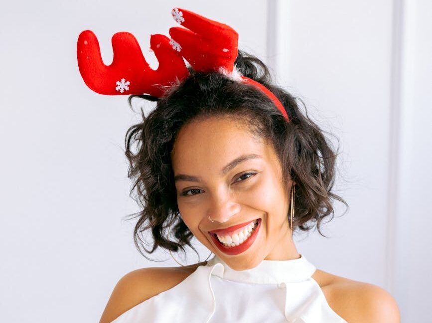 pexels-photo-6123674 a woman in white dress wearing a reindeer headband